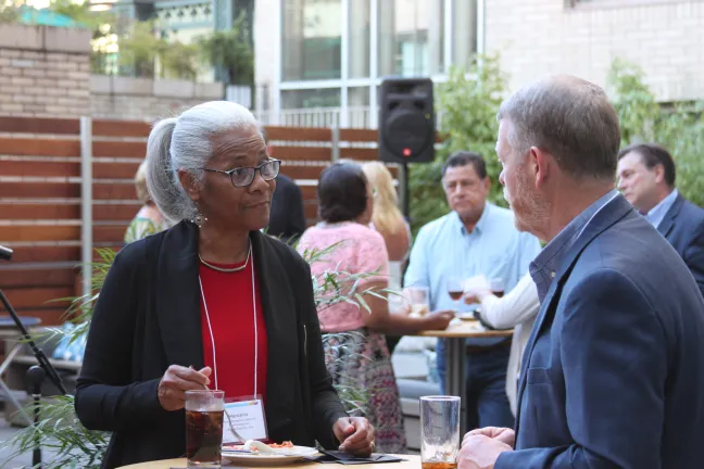 Elected officials visit at the gathering.