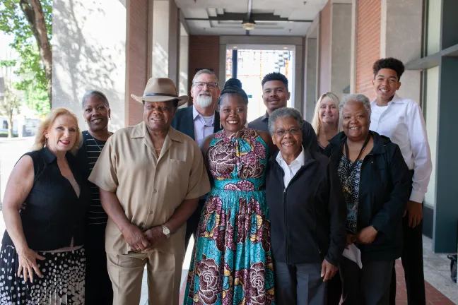 Newly appointed Department of Community Justice Director Erika Preuitt poses with family, including her father, Norman Sylvester (left) and mother Carmen Sylvester (right)