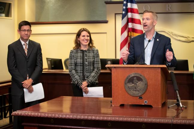 Mayor Ted Wheeler speaks alongside Chair Deborah Kafoury and Todd Struble of APANO on Sept. 17, 2019.