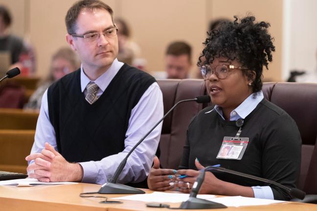 Ebony Clark, director of Mental Health and Addiction Services, right, lays out the preliminary program proposal for a downtown behavioral health resource center. 