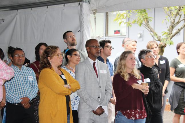 Kayse Jama, Executive Director of Unite Oregon, listens to speakers at Unite Oregon's Open House on September 7th