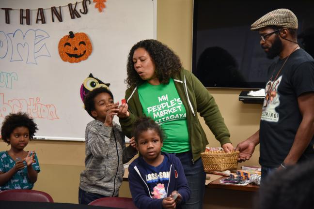 Farmer Shantae Johnson stops to paly during a harvest dinner celebrating REACH and Mudbone Grown partnership