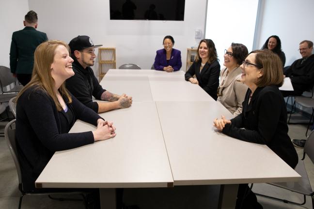 Commissioner Lori Stegmann, Chair Deborah Kafoury, Commissioner Jessica Vega Pederson and Gov. Kate Brown speak with shelter participants at the Laurelwood Center on Friday, Dec. 6, 2019.
