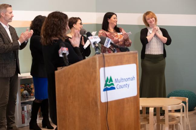 Brandi Tuck of Portland Homeless Family Solutions, right, while Chair Deborah Kafoury speaks at the opening of the Family Village shelter Dec. 16, 2019..