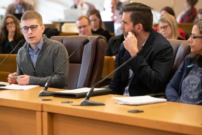 Cole Merkel, left, HereTogether Oregon's deputy director, speaks to the board at a briefing Tuesday, Jan. 14, 2020.