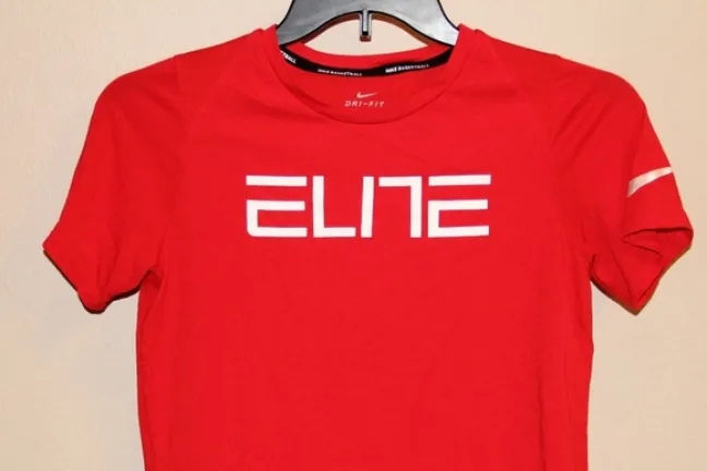When found, the woman wore a small red Nike DriFit t-shirt, with the word "ELITE" printed on the front.