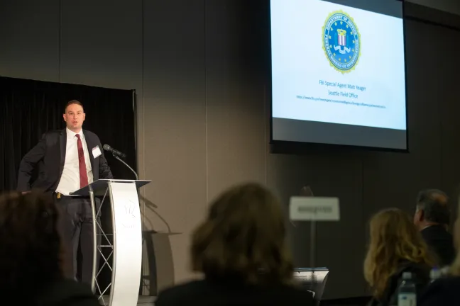 FBI Special Agent Matt Yeager speaks to guests at symposium on election and campaign security.
