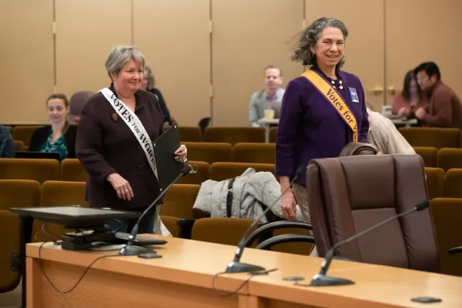 League of Women Voters of Portland’s past president Doreen Binder and current Board President Debbie Kaye walk up to present to board members.