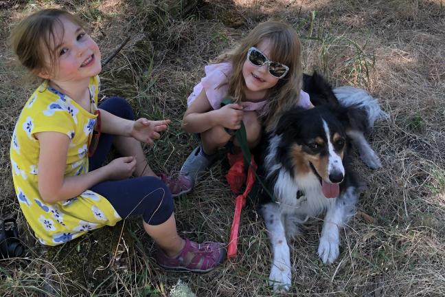 Two girls with their pet dog