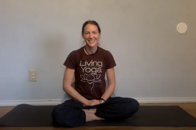 Woman sits in yoga pose