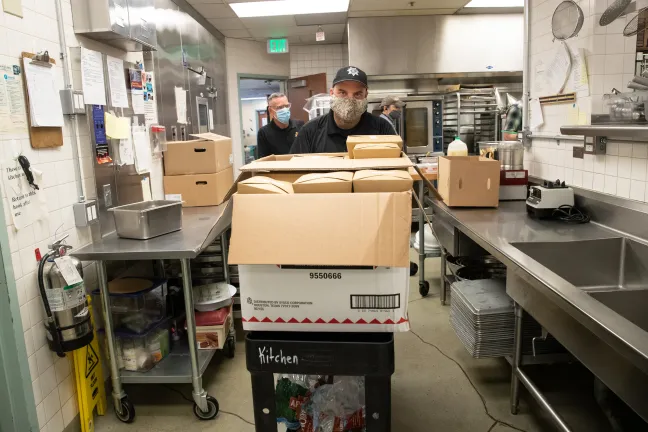 Mental Health Unit officers John McVay and Joe Wenhold pick up meals prepared by the County’s Juvenile Services Division’s Courtyard Café and Catering Service.