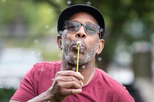 "I am planting positive seeds," said Jerry Hunter, blowing a dandelion seed head at the Hands of Wonder garden.