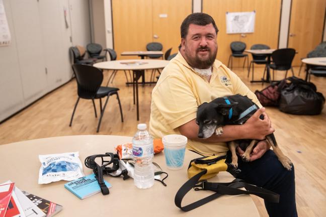 Chris Doll and his dog Junior came to Multnomah County East Building Cooling Center to avoid heat, July 29, 2021