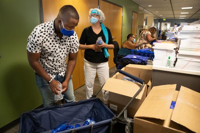 DCHS assembled 2,000 cooling kits for our vulnerable population. From left are DCHS team: Innocent Kisanga, Yvonne Flores, Margot Woods, and a community volunteer (facing back), July 30, 2021