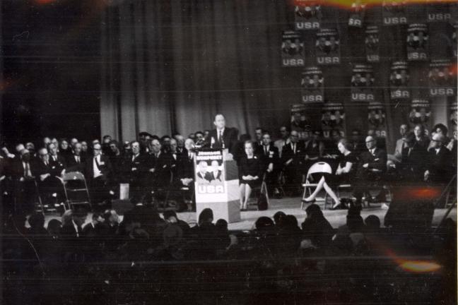 Black and white photograph of Hubert Humphrey speaking at a podium.