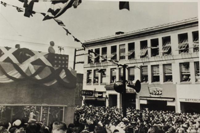 Black and white photograph of Harry S. Truman speaking to a crowd from the balcony of the Elks building in Bremerton, WA.