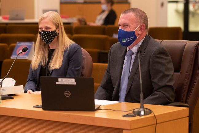 Multnomah County Assistant Attorney Katherine Thomas (left) sits with Multnomah County Elections Director Tim Scott (right).