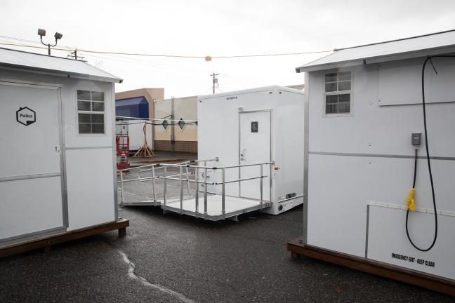 Sleeping pods and a bathroom trailer in the exterior portion of the Arbor Lodge Winter Shelter, hours before it opens Nov. 19, 2021.