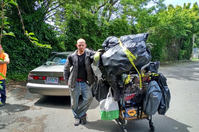 Harold Major stops for a photo with his belongings.