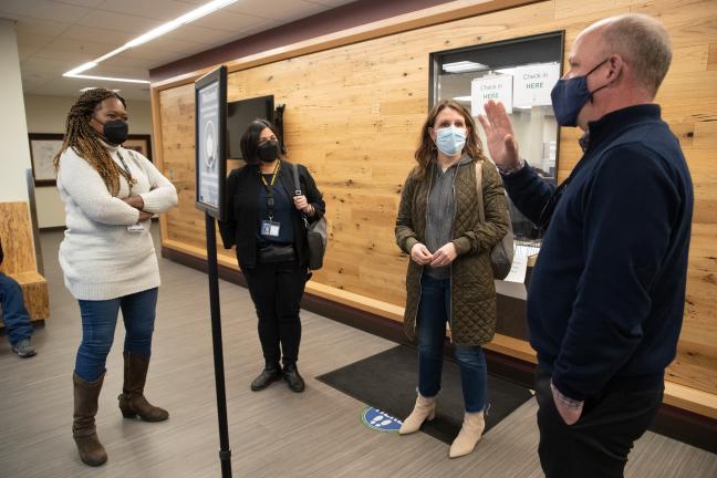 Natural wood lines the check-in windows of the lobby — coupled with brightly painted walls and gray marmoleum floors. Along the corridors, in public areas throughout the building, are pieces that make up an art installation called “Gallery Blue.”