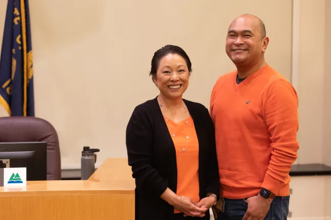 Commissioner Lori Stegmann and Piset Sao, constituent relations coordinator for Chair Deborah Kafoury, wear orange for gun safety.