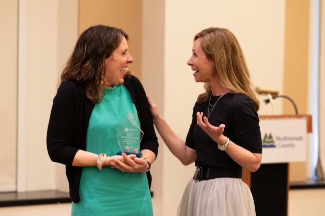 Chair Deborah Kafoury reacts to Budget Director Christian Elkin who presented her with a budget award for her years of service.