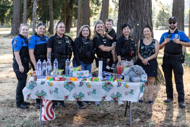 From left: Two Gresham Police cadets pose with Multnomah County parole and probation officers Amie Kellogg; Laura Vejar; Jamie Tynan and her son; Thanh Dang; Commissioner Lori Stegmann and a Gresham Police cadet. 