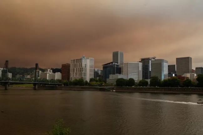 Smoke fills the skies above the Willamette River with downtown Portland in the background