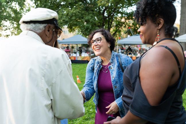 Commissioner Jessica Vega Pederson shakes hands with g Paul Knauls, known as the “honorary mayor” of Northeast Portland.