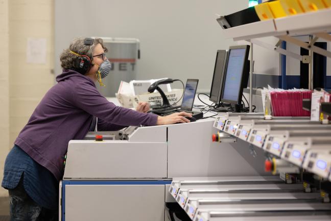 Heather Burmeister operates the sorter machine at Multnomah County Elections.