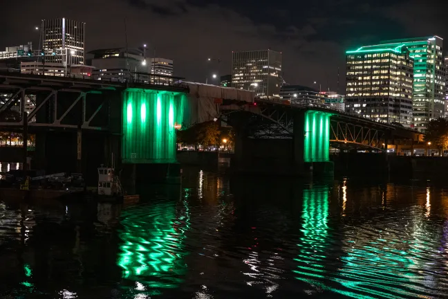The Morrison Bridge illuminated in green in honor of Operation Green Light
