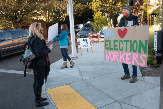 Photo shows a person holding a "We Love Election Workers" sign!