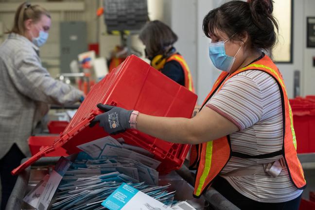 Election workers returning ballots from drop sites