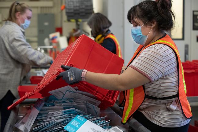 Election workers returning ballots from drop sites 