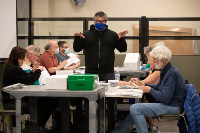 Greg Benavides provides direction to opening boards for election.