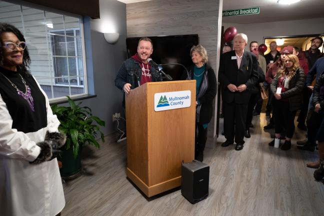 From left, All Good Northwest board chair A'Jay Scipio, All Good director Andy Goebel and Gresham Chamber of Commerce chair Lynn Snodgrass speak before a ribbon-cutting for the Rockwood Bridge Shelter on Jan. 13, 2022.