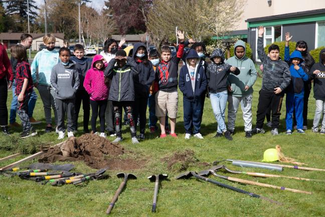 A group of children plant trees in Gresham