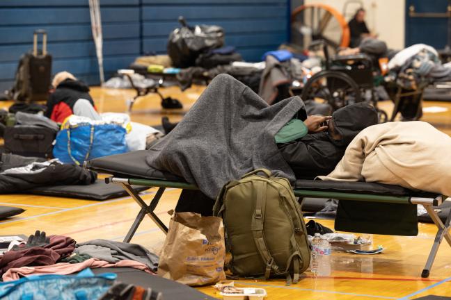 A person sleeps at the Salvation Army severe weather shelter