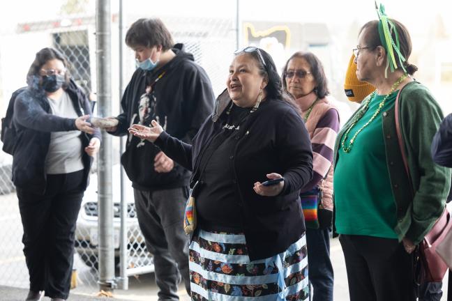 A group stands in a circle at the Future Generations Collaborative vaccine event