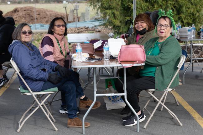 A group of elders eats dinner