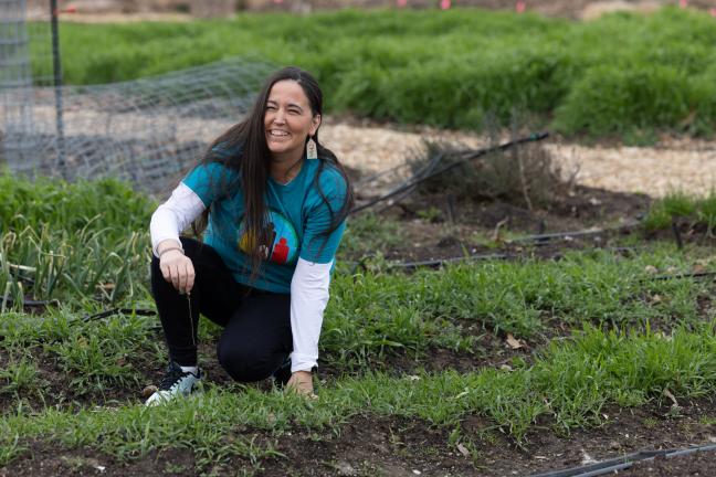 Jenny Brixey stands in the NAYA community garden