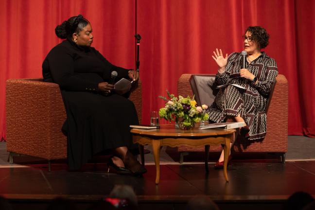 Chabre Vickers and Jessica Vega Pederson sit next to each other on stage