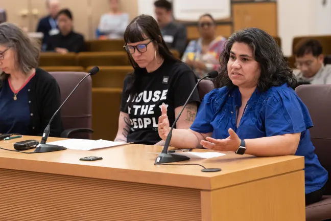 Perla Estrada and other community members speak during public hearing