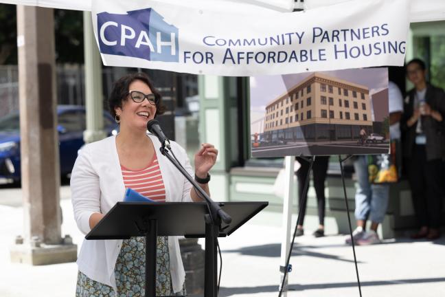 Chair Jessica Vega Pederson stands at a podium at the Joyce grand opening.