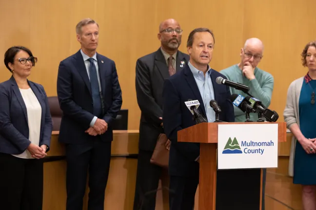 Dan Field stands at the dais in Multnomah County board chambers