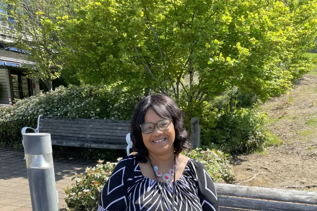 Nomika Gibson enjoys a quiet moment in front of John B. Yeon Annex, where she works at Patient Access Center.