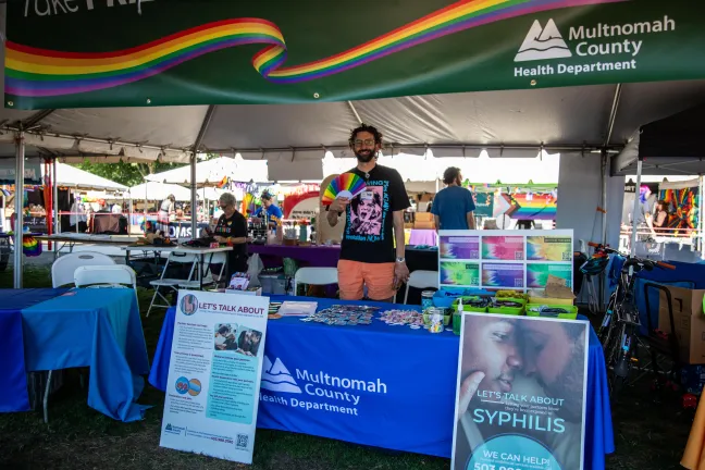 Griffin Pahl works a booth for Multnomah County's STI clinic