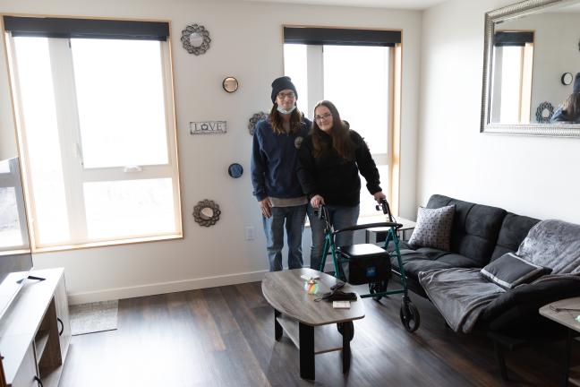 Two people stand in apartment