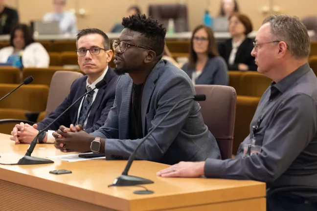 From left: Multnomah County Health Department interim director Valdez Bravo, Myque Obiero, director of Corrections Health (speaking) and  Dr. Elliott Lawson, Corrections Health medical director. 