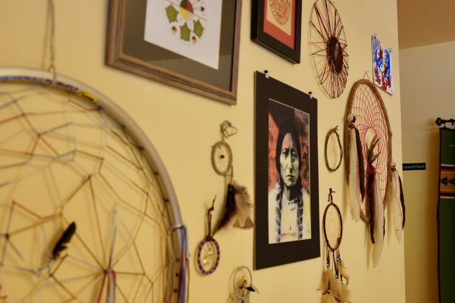 A wall with dream catchers and art.